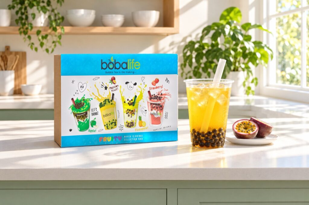 Fruity bubble tea kit box beside a passion fruit drink in a bright kitchen