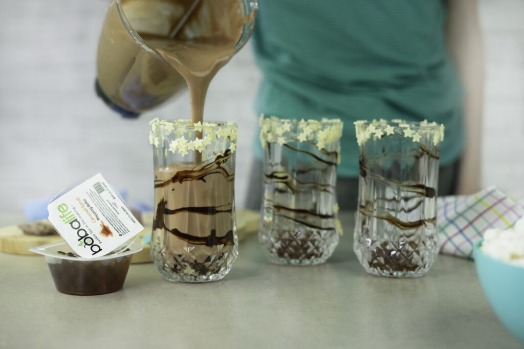 Three chocolate shakes being made